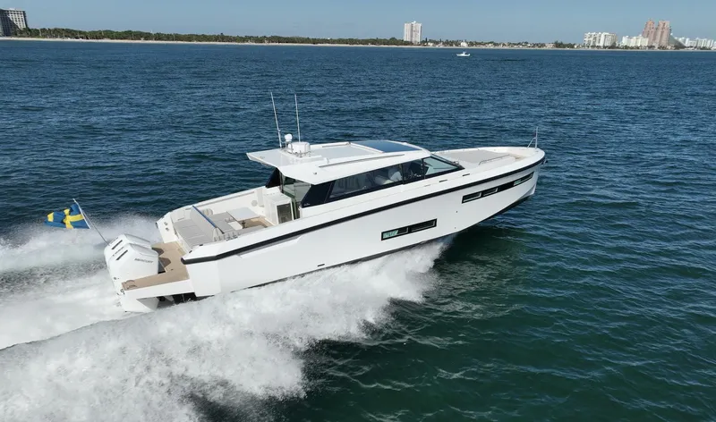  Yacht Photos Pics 2026 Delta Powerboats 48 Coupe cruising on open water, showcasing sleek design and performance.