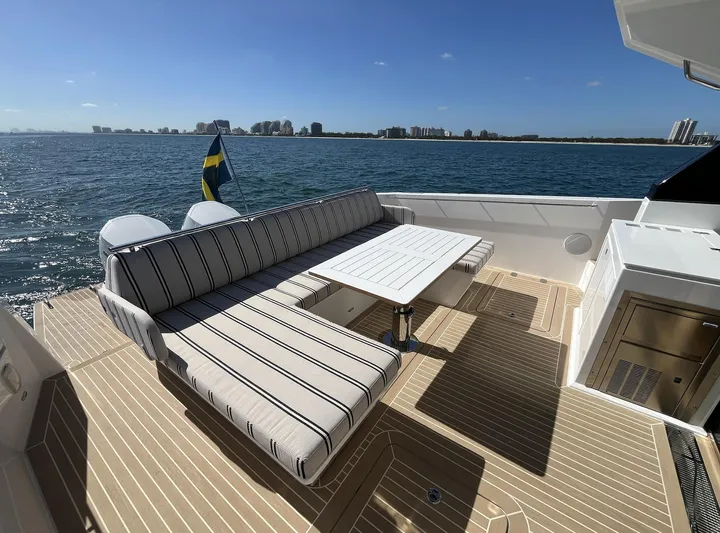  Yacht Photos Pics Luxurious 2026 Delta Powerboats 48 Coupe deck with striped seating and ocean view.