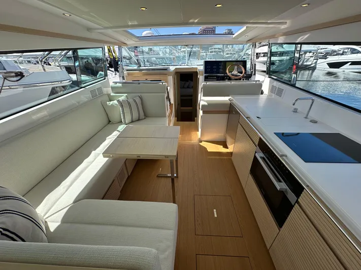  Yacht Photos Pics Luxurious interior of 2026 Delta Powerboats 48 Coupe with modern kitchen and seating area.