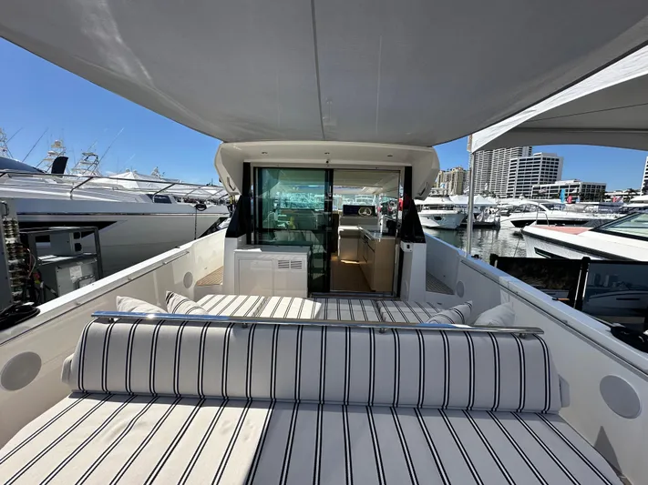  Yacht Photos Pics 2026 Delta Powerboats 48 Coupe with striped seating, docked at a marina.