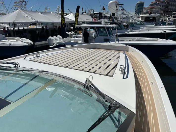  Yacht Photos Pics 2026 Delta Powerboats 48 Coupe at a marina, showcasing sleek design and luxury features.