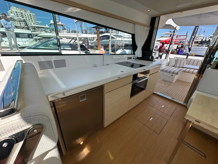  Yacht Photos Pics Modern interior of 2026 Delta Powerboats 48 Coupe, featuring sleek kitchen and outdoor seating.