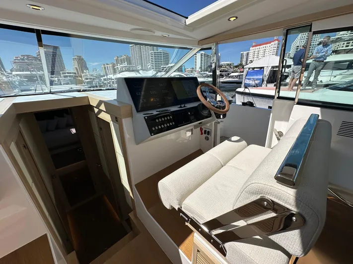  Yacht Photos Pics 2026 Delta Powerboats 48 Coupe helm with modern controls and cityscape view.