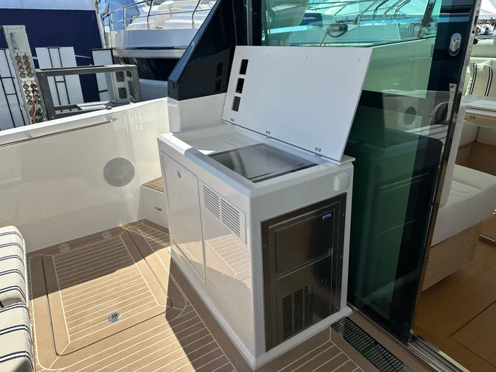  Yacht Photos Pics Outdoor kitchenette on 2026 Delta Powerboats 48 Coupe with sink and storage.