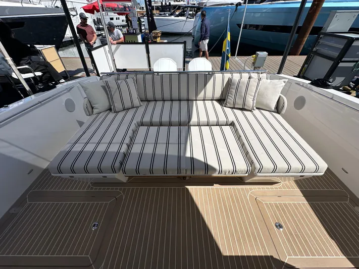  Yacht Photos Pics 2026 Delta Powerboats 48 Coupe with striped seating, docked at marina.