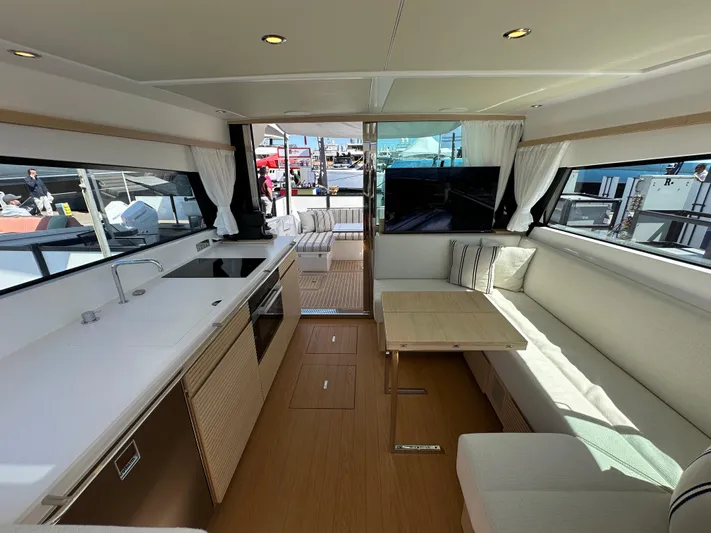  Yacht Photos Pics Luxurious interior of 2026 Delta Powerboats 48 Coupe with modern kitchen and seating area.