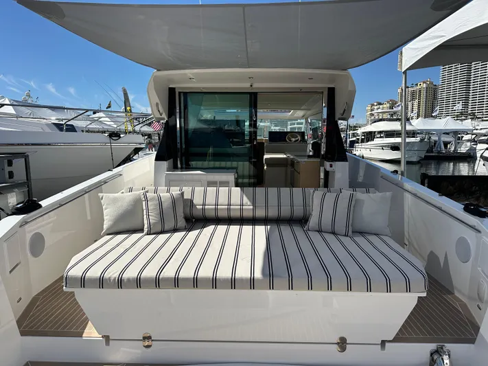  Yacht Photos Pics 2026 Delta Powerboats 48 Coupe with striped seating, docked at a marina under clear skies.