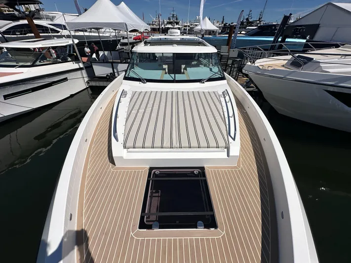  Yacht Photos Pics 2026 Delta Powerboats 48 Coupe at marina, showcasing sleek deck design and modern features.