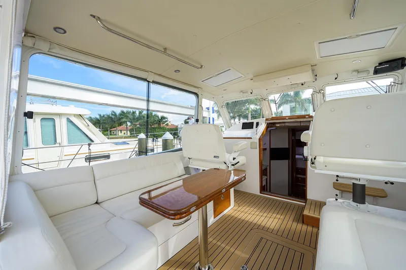 Scout Yacht Photos Pics Luxurious interior of 2019 MJM 43z yacht with white seating and wooden accents.