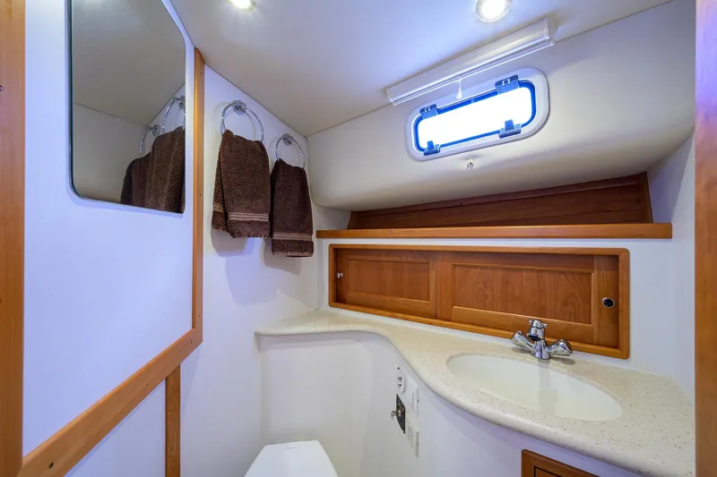 Scout Yacht Photos Pics Luxurious bathroom in 2019 MJM 43z yacht with modern fixtures and wooden accents.