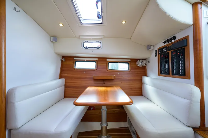 Scout Yacht Photos Pics Interior of 2019 MJM 43z yacht with wooden table and white seating.