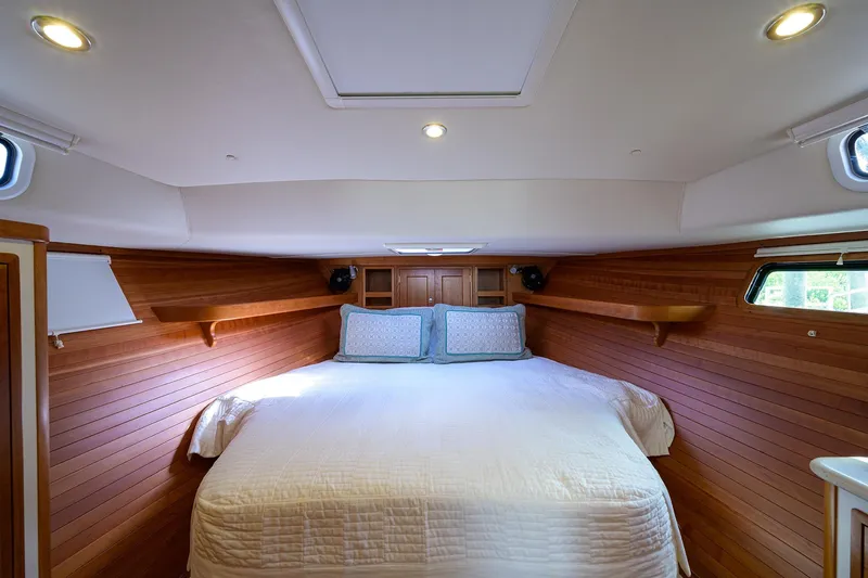 Scout Yacht Photos Pics Luxurious cabin interior of 2019 MJM 43z yacht with cozy bedding and wooden paneling.