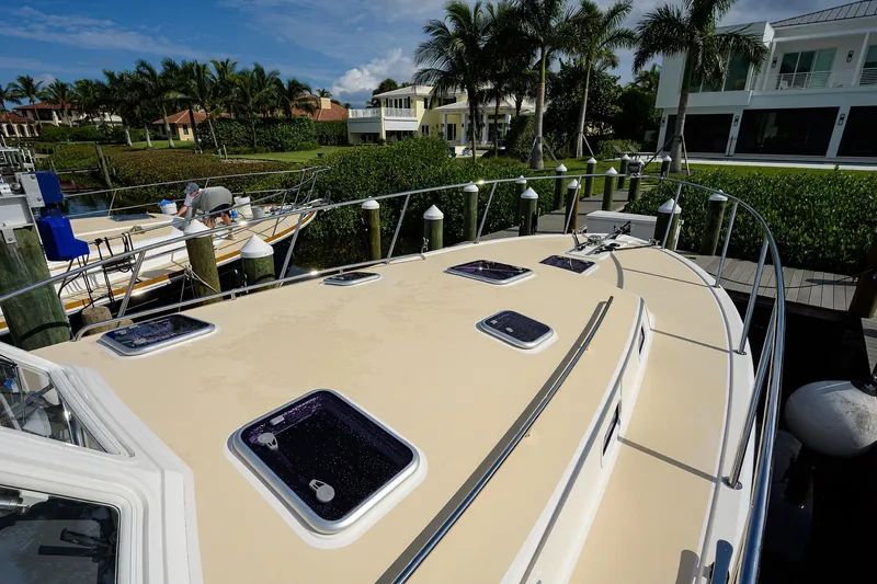 Scout Yacht Photos Pics 2019 MJM 43z yacht docked near waterfront homes and palm trees.