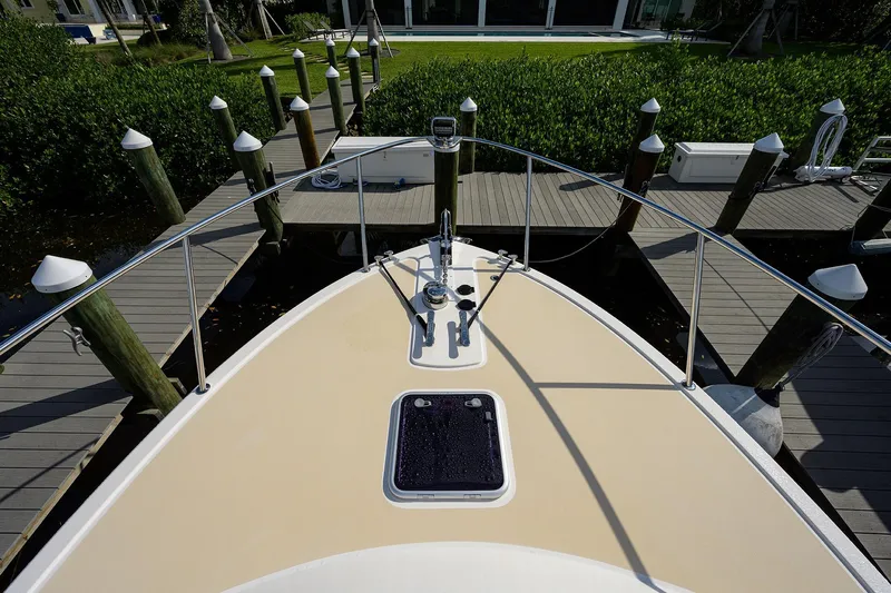 Scout Yacht Photos Pics Bow view of 2019 MJM 43z yacht docked at marina with lush greenery.