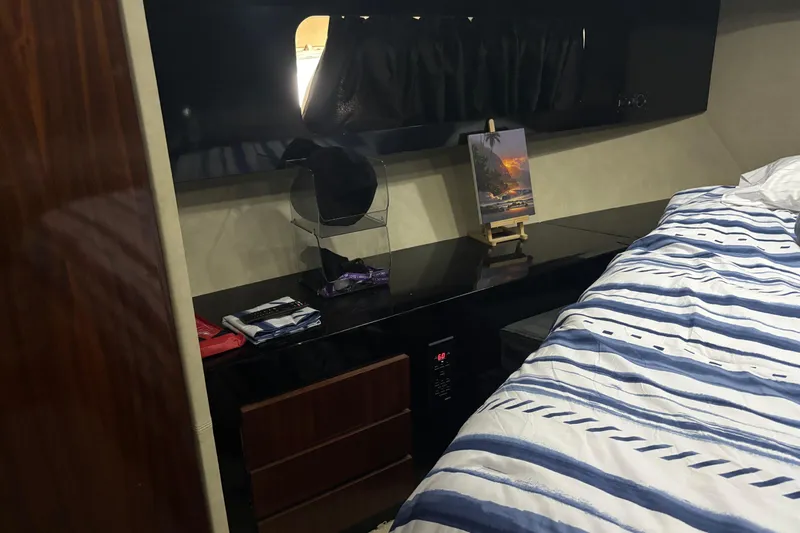  Yacht Photos Pics Cozy cabin interior of 1986 Maiora Phantom yacht with striped bedding and sleek furnishings.