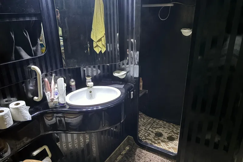  Yacht Photos Pics Luxurious 1986 Maiora Phantom bathroom with sleek black design and modern amenities.