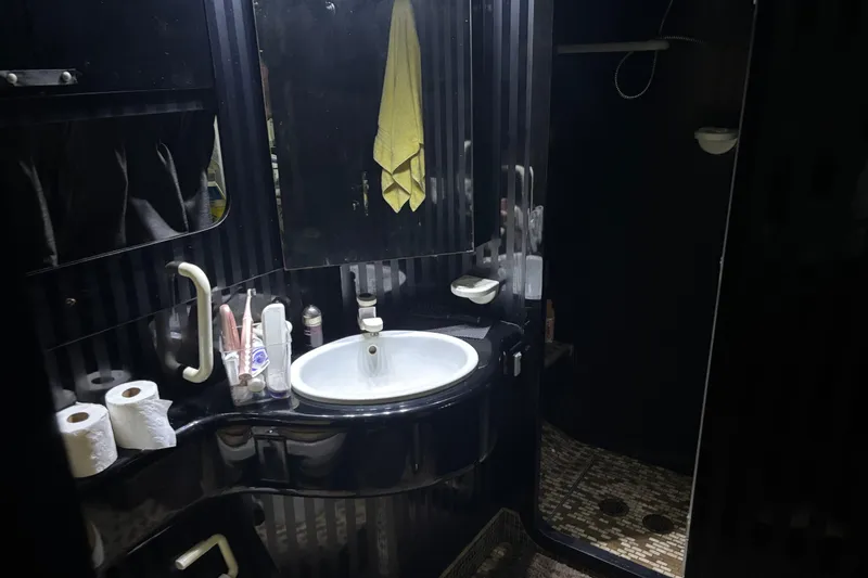  Yacht Photos Pics Luxurious 1986 Maiora Phantom bathroom with sleek black design and modern amenities.