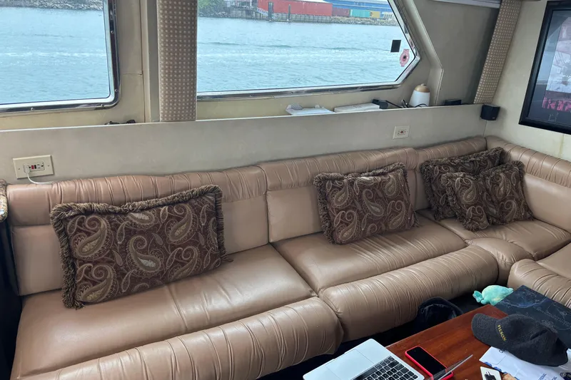  Yacht Photos Pics Luxurious interior of 1986 Maiora Phantom yacht with plush seating and decorative pillows.