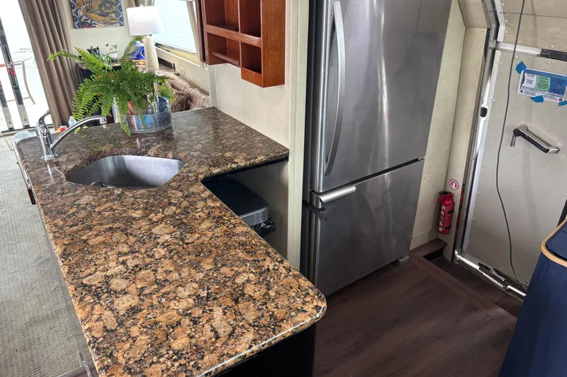  Yacht Photos Pics Luxurious kitchen interior of 1986 Maiora Phantom yacht with granite countertops and stainless steel appliances.