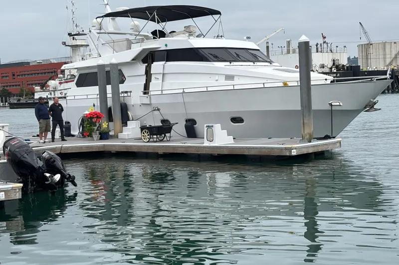  Yacht Photos Pics 1986 Maiora Phantom yacht docked at marina with people nearby, overcast sky.