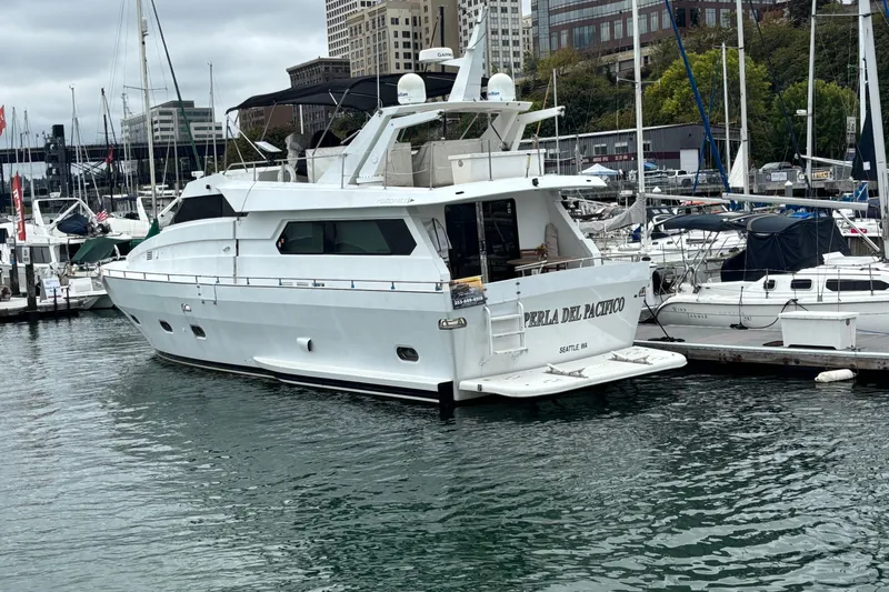  Yacht Photos Pics Luxury yacht Maiora Phantom 1986 docked in a marina, surrounded by other boats.