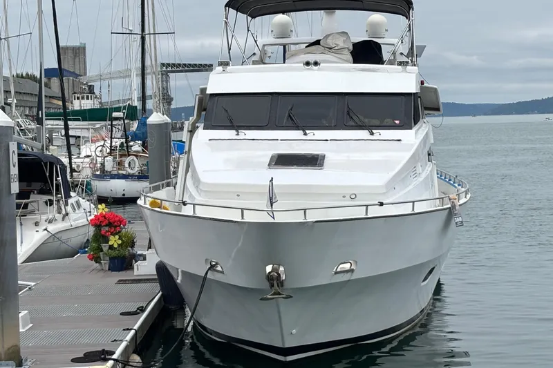  Yacht Photos Pics 1986 Maiora Phantom yacht docked at marina, surrounded by other boats and flowers.