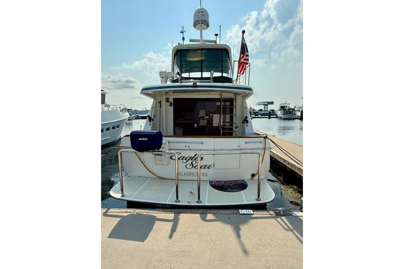 Eagles Soar Yacht Photos Pics Hampton 490 yacht, year 2000, docked at marina with American flag.