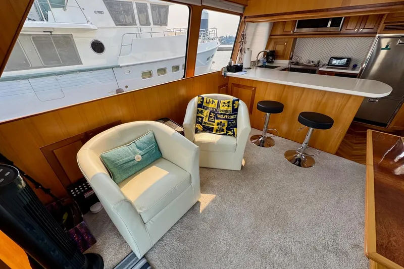 Eagles Soar Yacht Photos Pics Interior of 2000 Hampton 490 yacht with cozy seating and modern kitchen area.