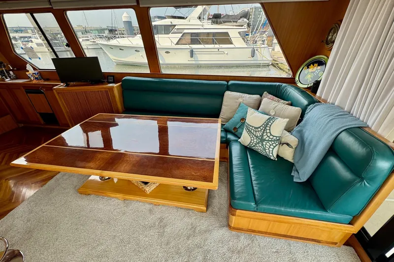 Eagles Soar Yacht Photos Pics Luxurious interior of a 2000 Hampton 490 yacht with plush seating and elegant table.