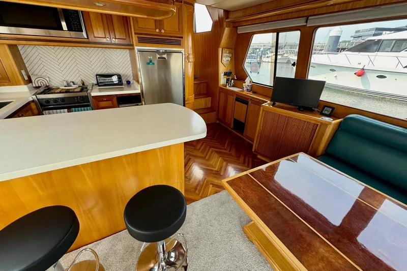 Eagles Soar Yacht Photos Pics Luxurious interior of a 2000 Hampton 490 yacht with modern kitchen and seating area.