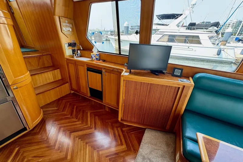 Eagles Soar Yacht Photos Pics Interior of 2000 Hampton 490 yacht with wood finish and marina view.