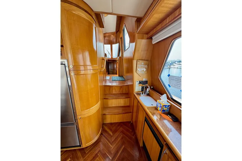 Eagles Soar Yacht Photos Pics Interior of 2000 Hampton 490 yacht with wooden cabinetry and nautical decor.