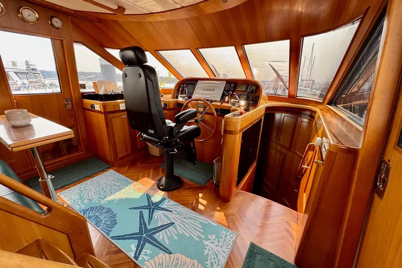 Eagles Soar Yacht Photos Pics Luxurious 2000 Hampton 490 yacht interior with wooden helm, seating, and nautical decor.