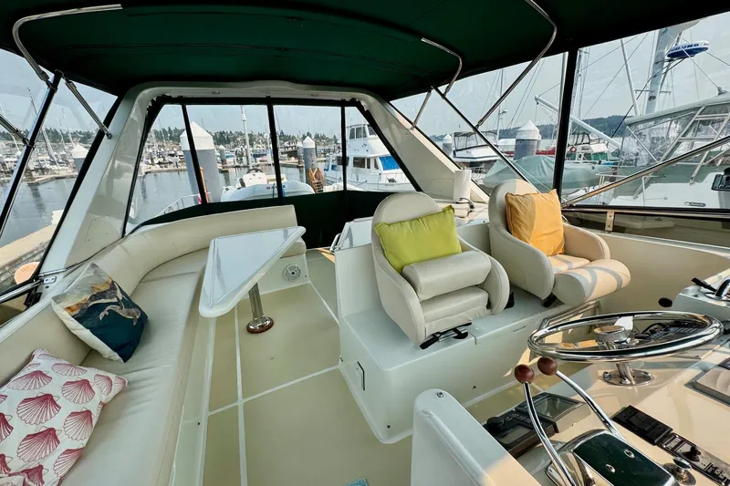Eagles Soar Yacht Photos Pics Luxurious 2000 Hampton 490 yacht interior with plush seating and helm, docked at marina.