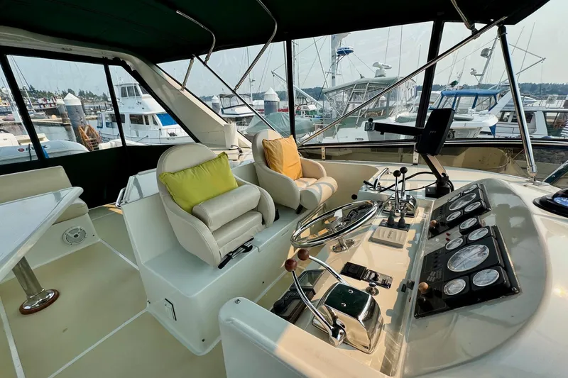 Eagles Soar Yacht Photos Pics Interior view of a 2000 Hampton 490 yacht cockpit with steering wheel and control panels.