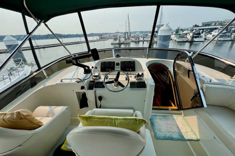 Eagles Soar Yacht Photos Pics Luxurious 2000 Hampton 490 yacht interior with helm, marina view, and plush seating.