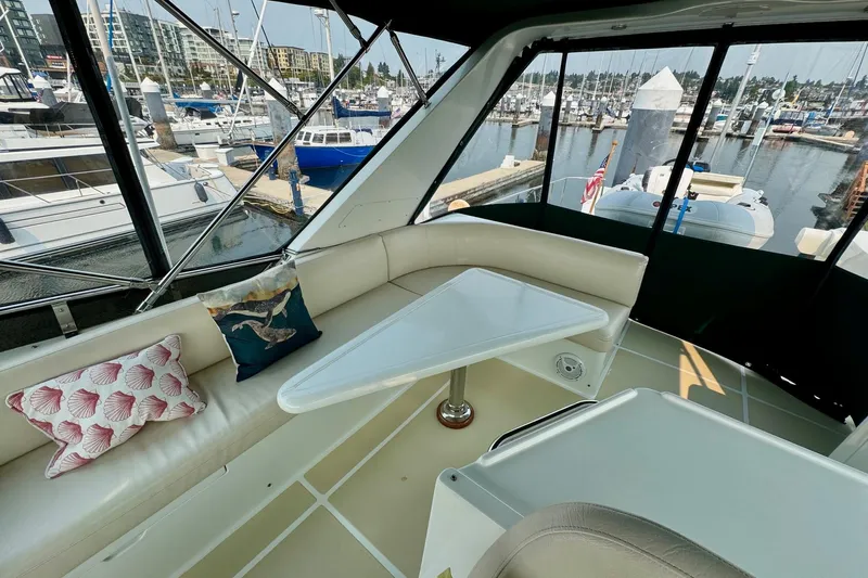 Eagles Soar Yacht Photos Pics Luxurious 2000 Hampton 490 yacht interior with marina view, featuring plush seating and decorative pillows.