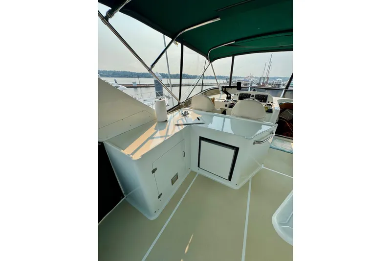 Eagles Soar Yacht Photos Pics Helm area of 2000 Hampton 490 yacht with green canopy and marina view.