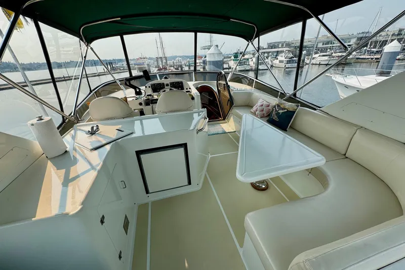 Eagles Soar Yacht Photos Pics Luxurious interior of 2000 Hampton 490 yacht with seating and helm, docked at marina.