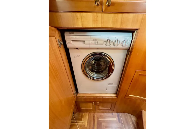 Eagles Soar Yacht Photos Pics Compact washing machine in wooden cabinet on a 2000 Hampton 490 yacht.