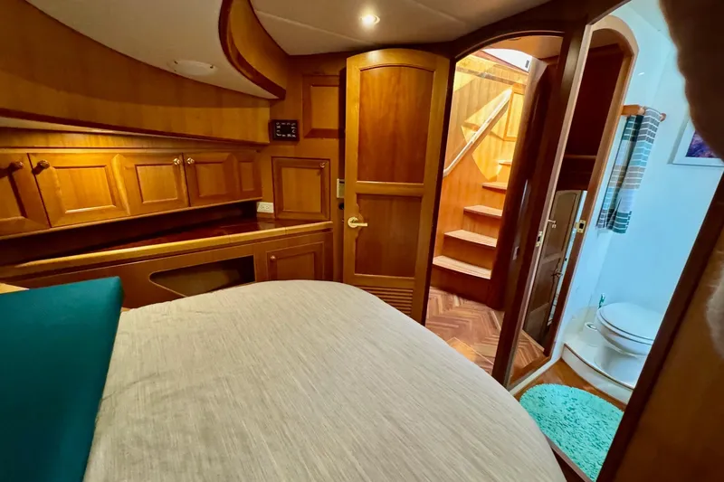 Eagles Soar Yacht Photos Pics Luxurious 2000 Hampton 490 yacht interior with wooden cabinetry and cozy bedroom.