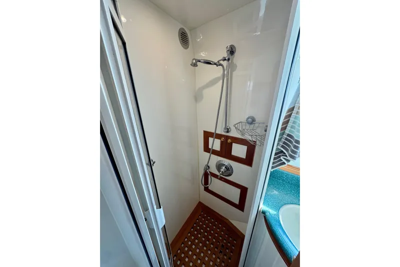 Eagles Soar Yacht Photos Pics Compact shower in 2000 Hampton 490 yacht with wooden accents and modern fixtures.