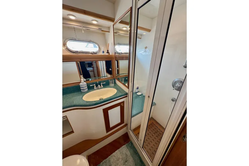 Eagles Soar Yacht Photos Pics Luxurious bathroom in 2000 Hampton 490 yacht with shower, sink, and mirror.