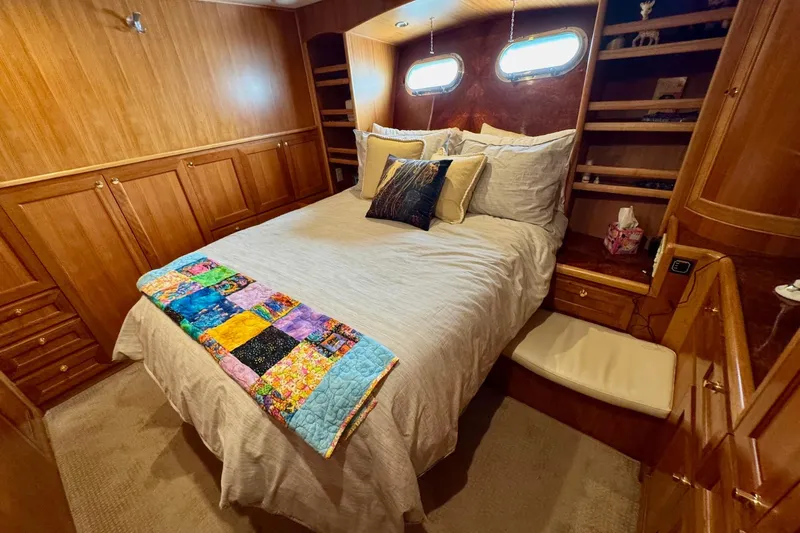 Eagles Soar Yacht Photos Pics Luxurious bedroom in 2000 Hampton 490 yacht with wood paneling and colorful quilt.