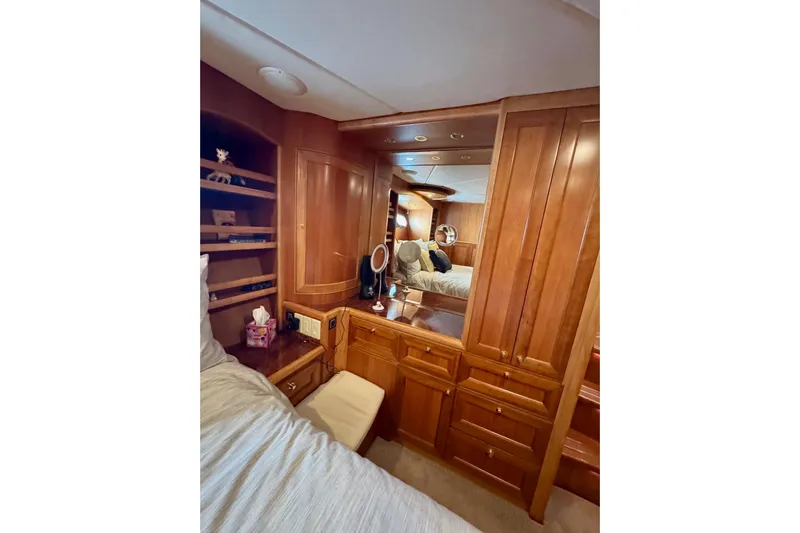 Eagles Soar Yacht Photos Pics Luxurious wooden interior of 2000 Hampton 490 yacht bedroom with mirror and storage.