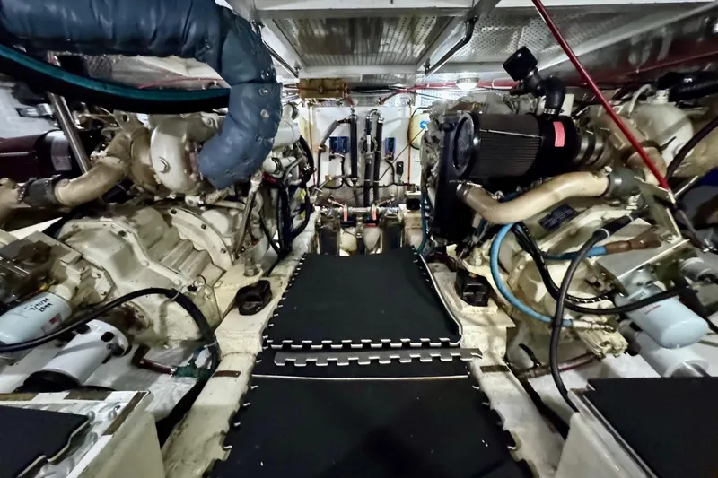 Eagles Soar Yacht Photos Pics Engine room of a 2000 Hampton 490 yacht, showcasing dual engines and mechanical components.