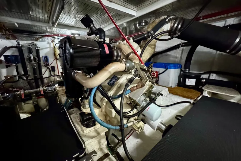 Eagles Soar Yacht Photos Pics Engine room of a 2000 Hampton 490 yacht, showcasing mechanical components and piping.