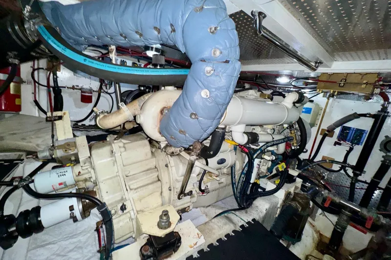 Eagles Soar Yacht Photos Pics Engine room of a 2000 Hampton 490 yacht, showcasing complex machinery and piping.