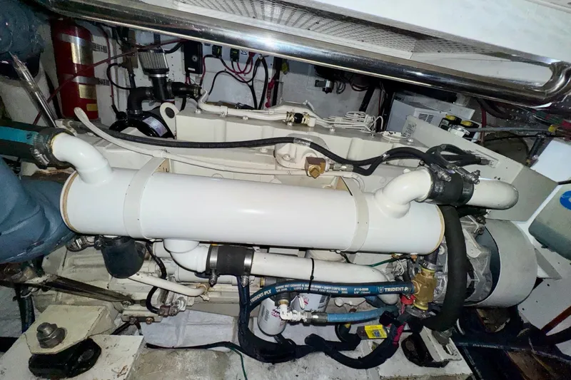Eagles Soar Yacht Photos Pics Engine room of a 2000 Hampton 490 yacht, showcasing mechanical components and piping.
