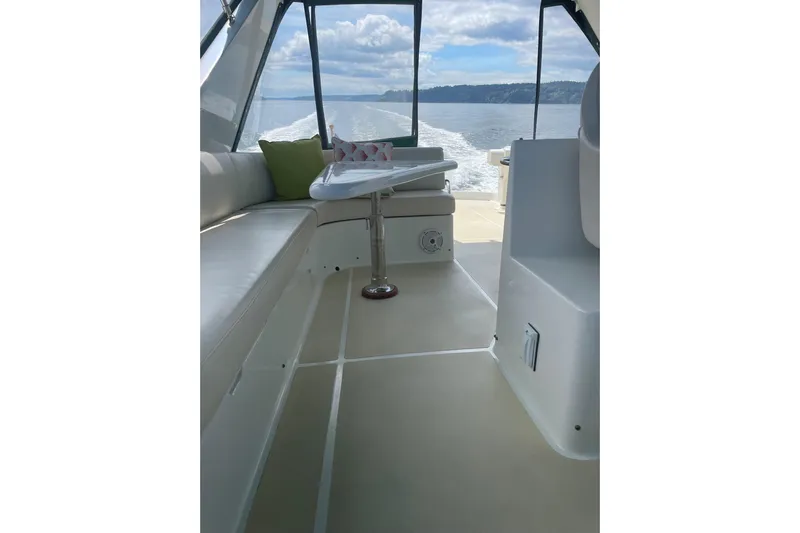 Eagles Soar Yacht Photos Pics Interior view of 2000 Hampton 490 yacht with seating and table, cruising on open water.